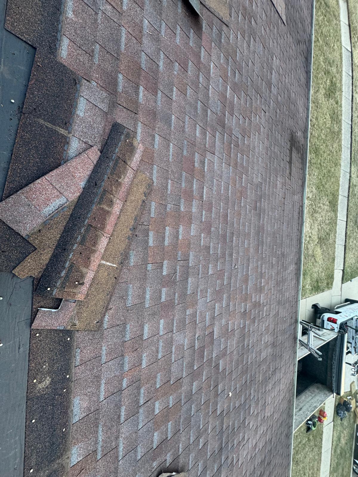 Storm-damaged shingles documented before replacement — roof replacement, storm damage roof repair, roof inspection, roof decking replacement, synthetic underlayment, completed roof installation, New Gen 180 LLC, Elgin IL, residential roofing