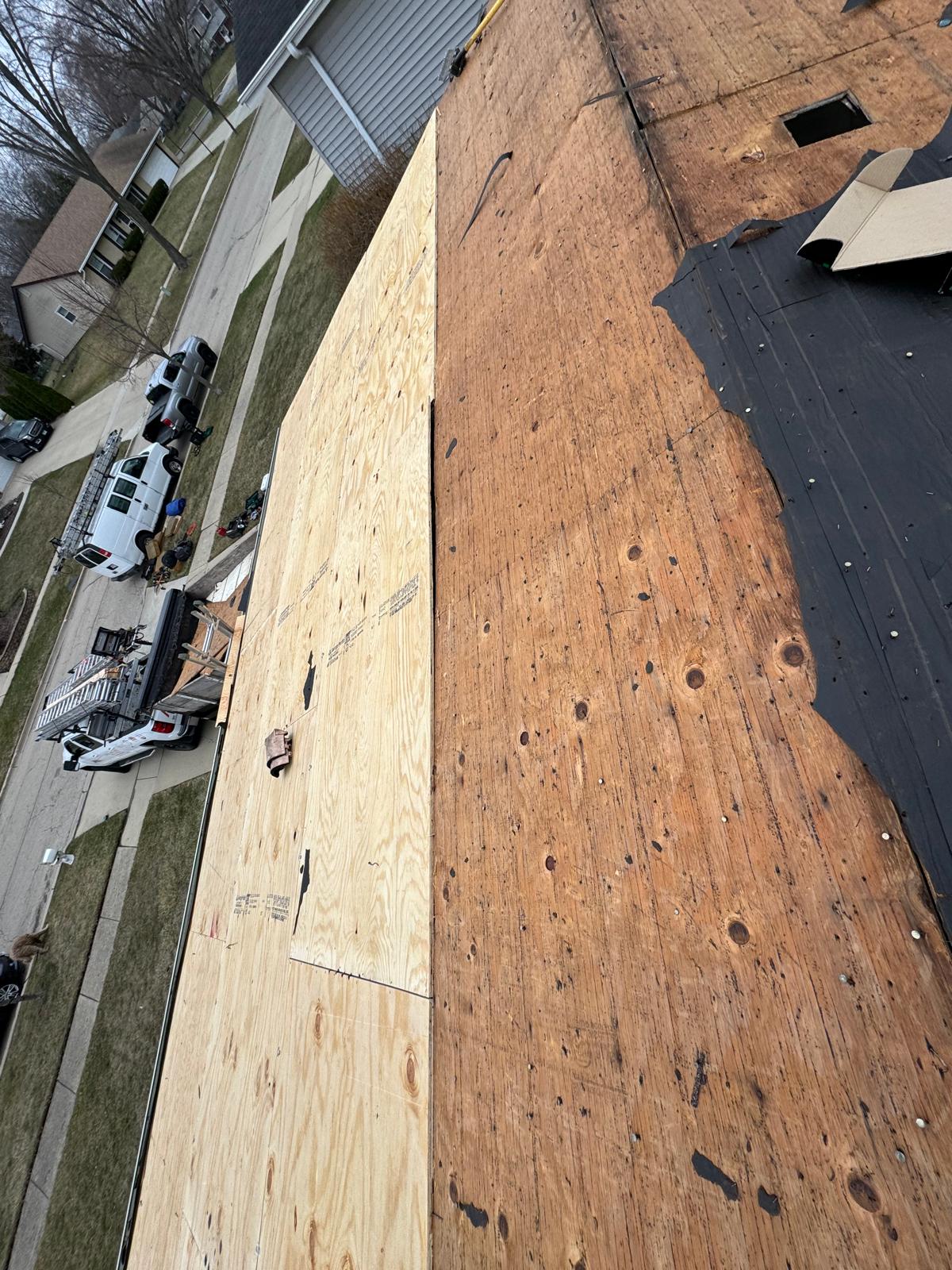 New plywood next to old decking comparison — roof replacement, storm damage roof repair, roof inspection, roof decking replacement, synthetic underlayment, completed roof installation, New Gen 180 LLC, Elgin IL, residential roofing